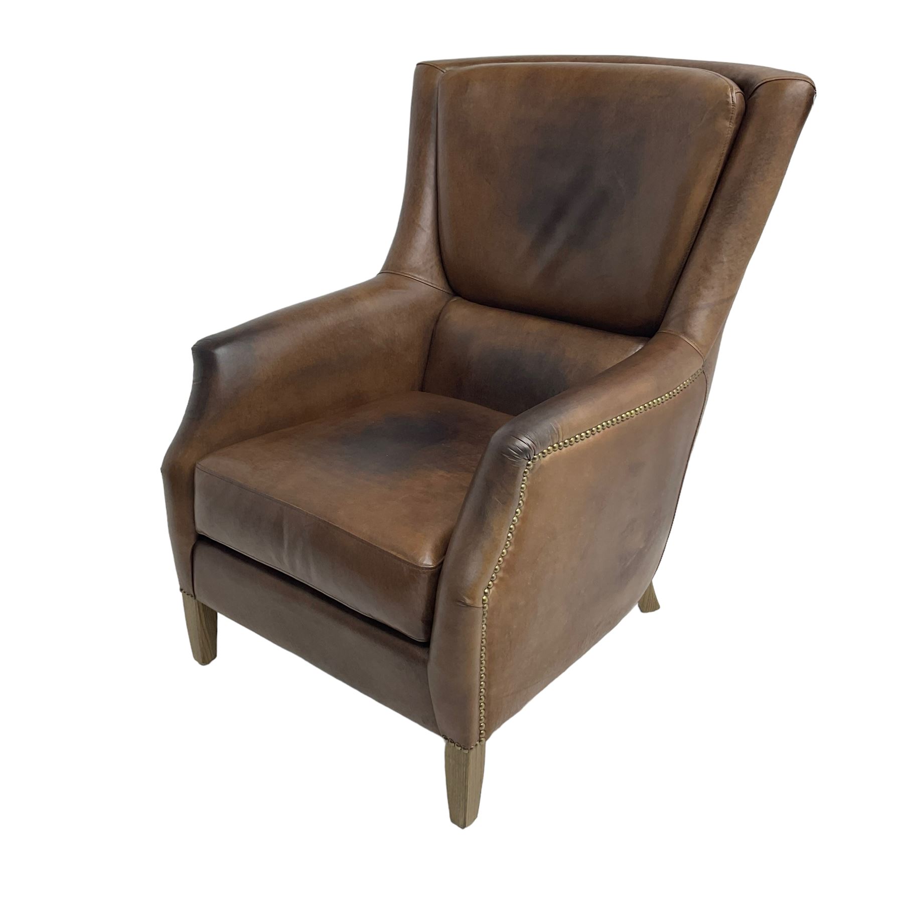 Club reading armchair, upholstered in brown Brazilian leather, studded detail, oak tapering legs