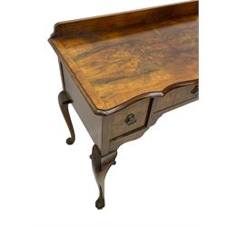 Mid-to-late 20th century figured walnut side table, raised back over figured top with cross banding and shaped front, fitted with three drawers, on cabriole supports with carved terminals 