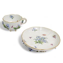 Pair of Meissen tea cups and saucers, encrusted with forget-me-nots and decorated with flowers and insects, raised on peg feet, H8cm and an early 20th century Meissen teapot, decorated with courting couples, H12cm (3)