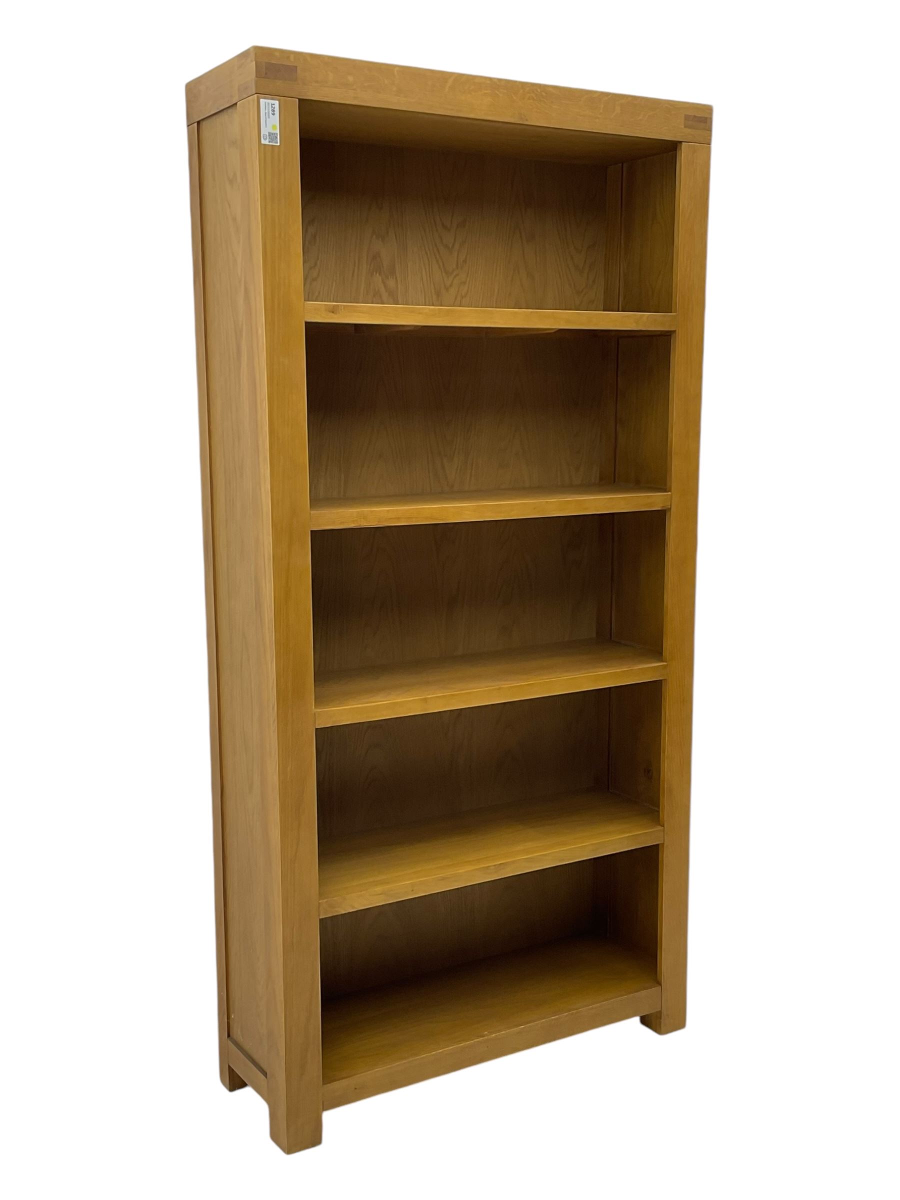 Light oak open bookcase fitted with four shelves 