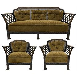 Early 20th century three-piece bergère suite - three seat sofa (W177cm, H82cm, D75cm); pair of matching armchairs (W84cm); single caned back with 'cock-pen' panelled arms, upholstered in foliate pattern fabric, blind fretwork lower frieze over square feet 