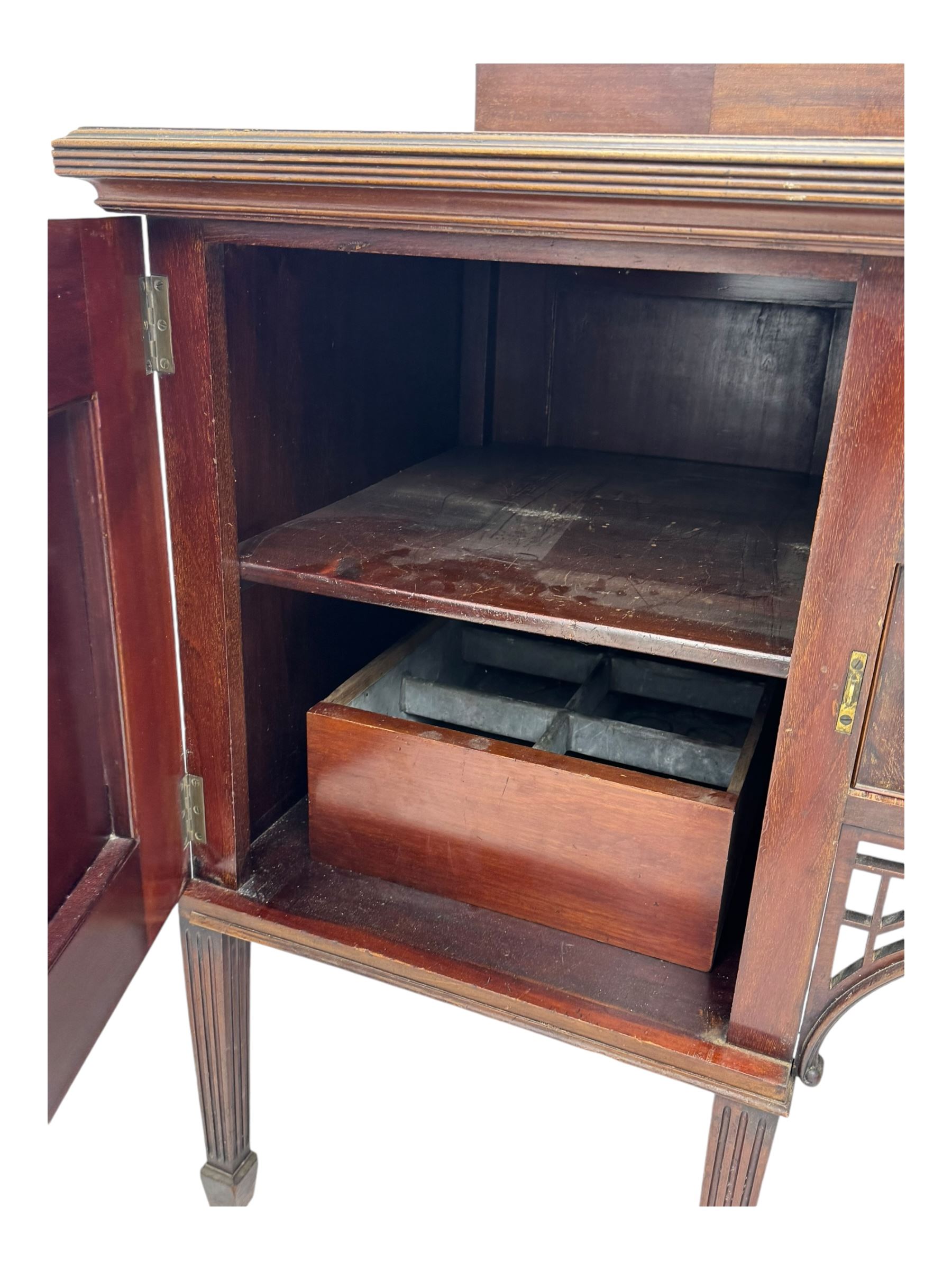 19th century mahogany sideboard, raised mirror back with carved fretwork and two fluted columns, above two cupboards and two drawers with lion mask handles