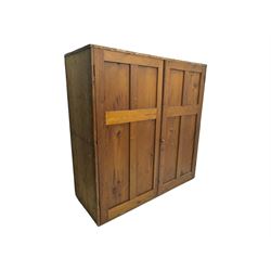 Large 19th century pine cupboard, rectangular top over two panelled later doors, enclosing four open shelves, on plinth base