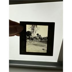 Collection of magic lantern slides, predominantly depicting views of India, with scenes including including the Taj Mahal, tombs, monuments, street scenes, people and animals, in compartmentalised wooden case 