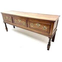 George III cross banded oak dresser, three drawers, shaped brass handles, baluster supports