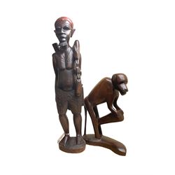 Two African carved hardwood figures, the first carved as a monkey, H43cm, the second as a male figure, H70cm