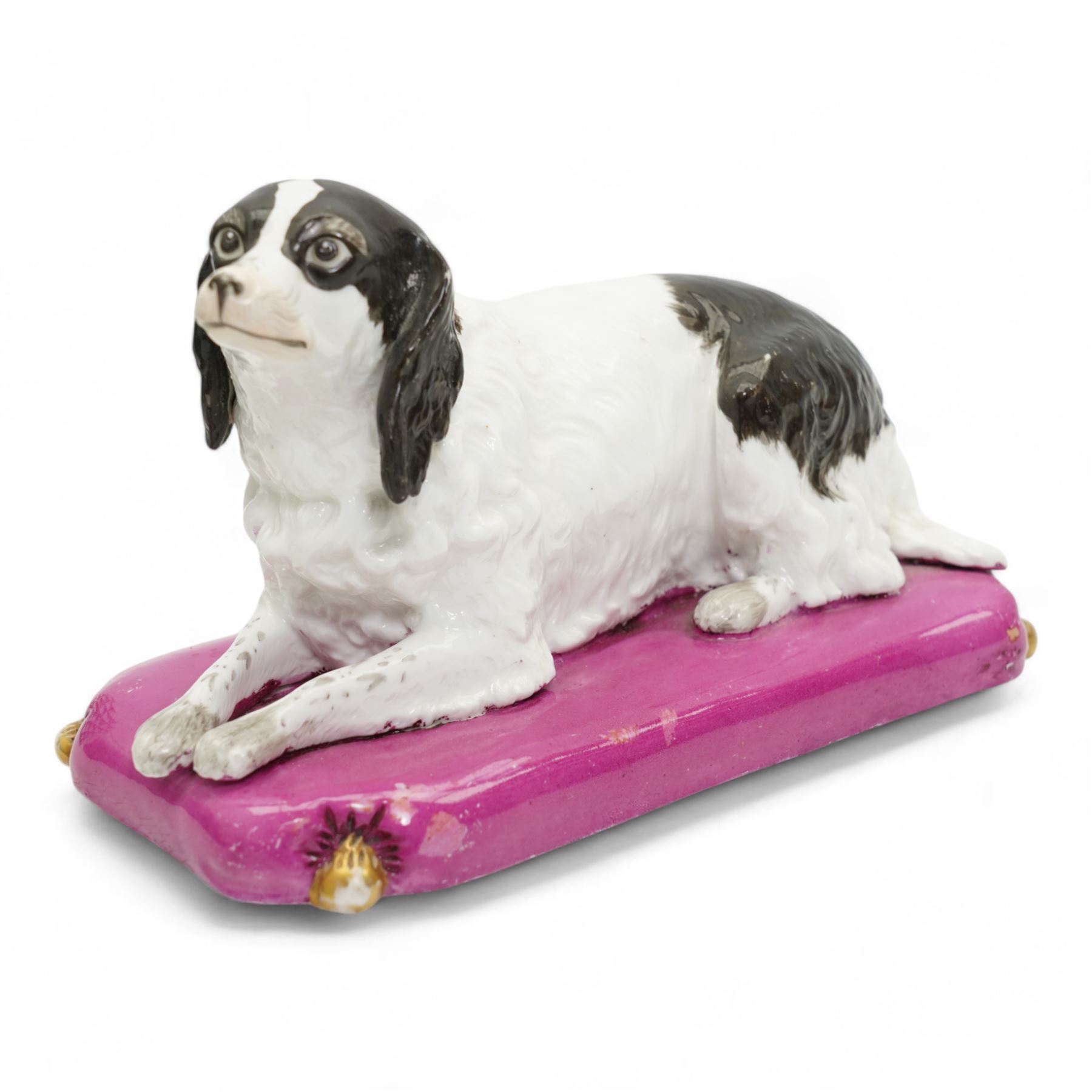 Mid 19th century Copeland & Garrett model of a recumbent spaniel upon a pink tasselled cushion, printed marks beneath, L20cm x H12cm