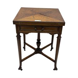 Victorian rosewood envelope games table, the moulded square top with four triangular hinged leaves, revealing inset baize playing surface and sunken counter wells, fitted with single frieze drawer, on square tapering supports united by x-framed stretchers and turned central column, on brass and ceramic castors 