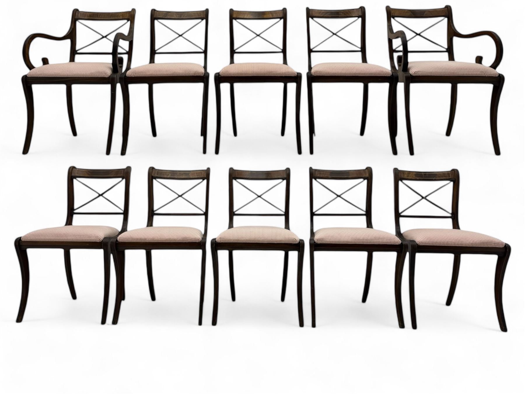 Set of ten (8+2) Regency design mahogany and brass inlaid dining chairs, bar cresting rail over x-framed back, upholstered drop-in seats, moulded frame and sabre supports 