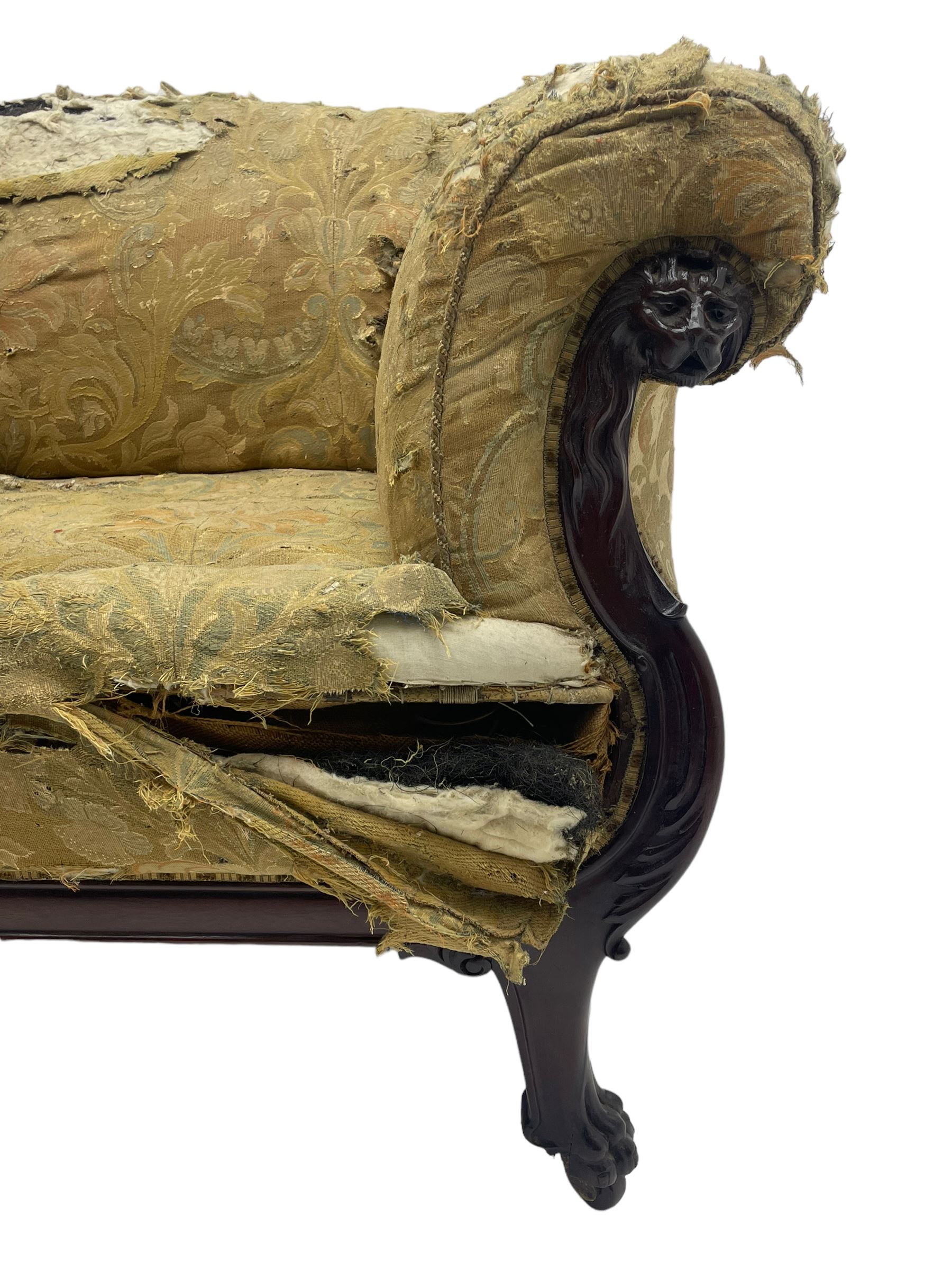 19th century mahogany settee, rolled S-scrolled arms carved with lion masks and acanthus leaf scrolls, the lower moulded rail carved with scrolling design, raised on carved paw feet with recessed brass and ceramic castors 