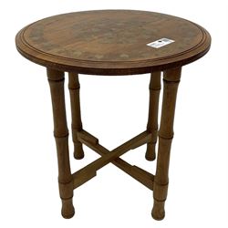 Small brass inlaid hardwood occasional table, the circular top inlaid with trailing foliate decoration, on turned folding base 