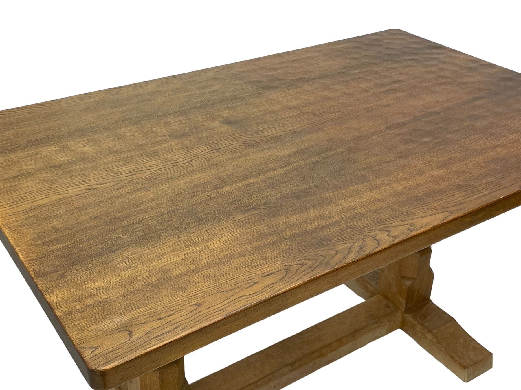 Mouseman - oak dining table, rectangular adzed top with rounded corners, octagonal pillar supports on sledge feet united by floor stretcher, carved with mouse signature, by the workshop of Robert Thompson, Kilburn