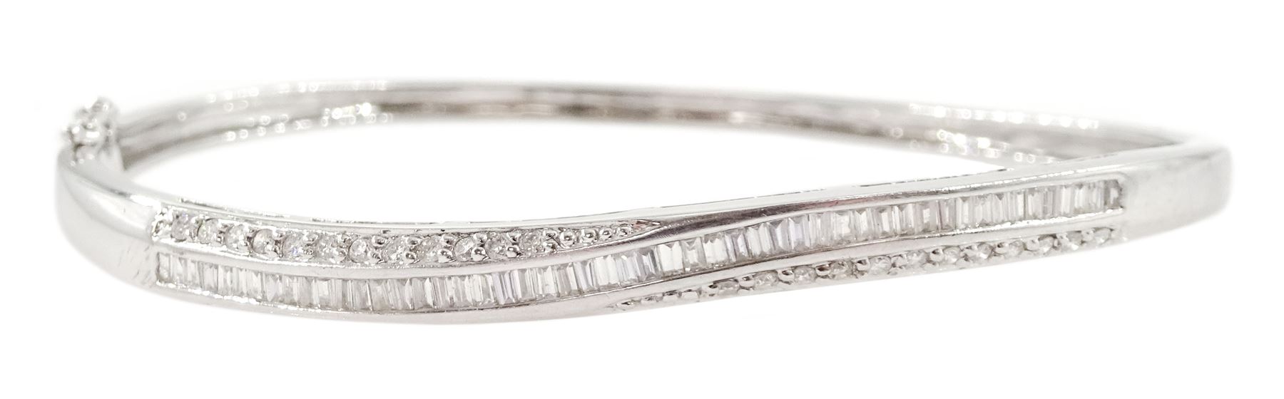 18ct white gold channel set round brilliant cut and baguette cut diamond twist bangle, Sheffield 2002, total diamond weight approx 1.00 carat