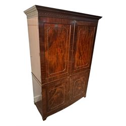 Victorian mahogany linen press, projecting cornice with dentil and scroll detailing, double panelled doors opening to an interior fitted with a brass hanging rail and coat hooks, lower section with two drawers and fitted shelves for additional storage, raised on bracket feet