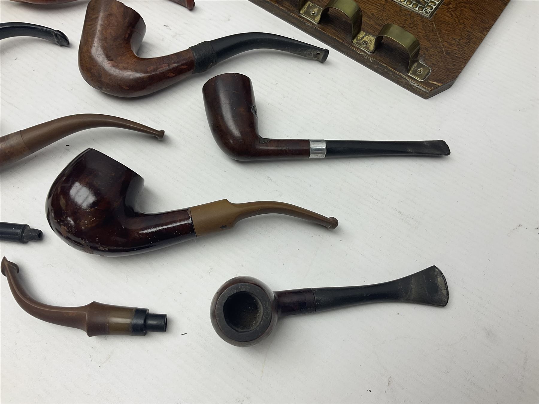 Collection of smoking pipes including Meerschaum pipe, carved as a female head, Briars and clay examples, etc and four pipe racks/stands