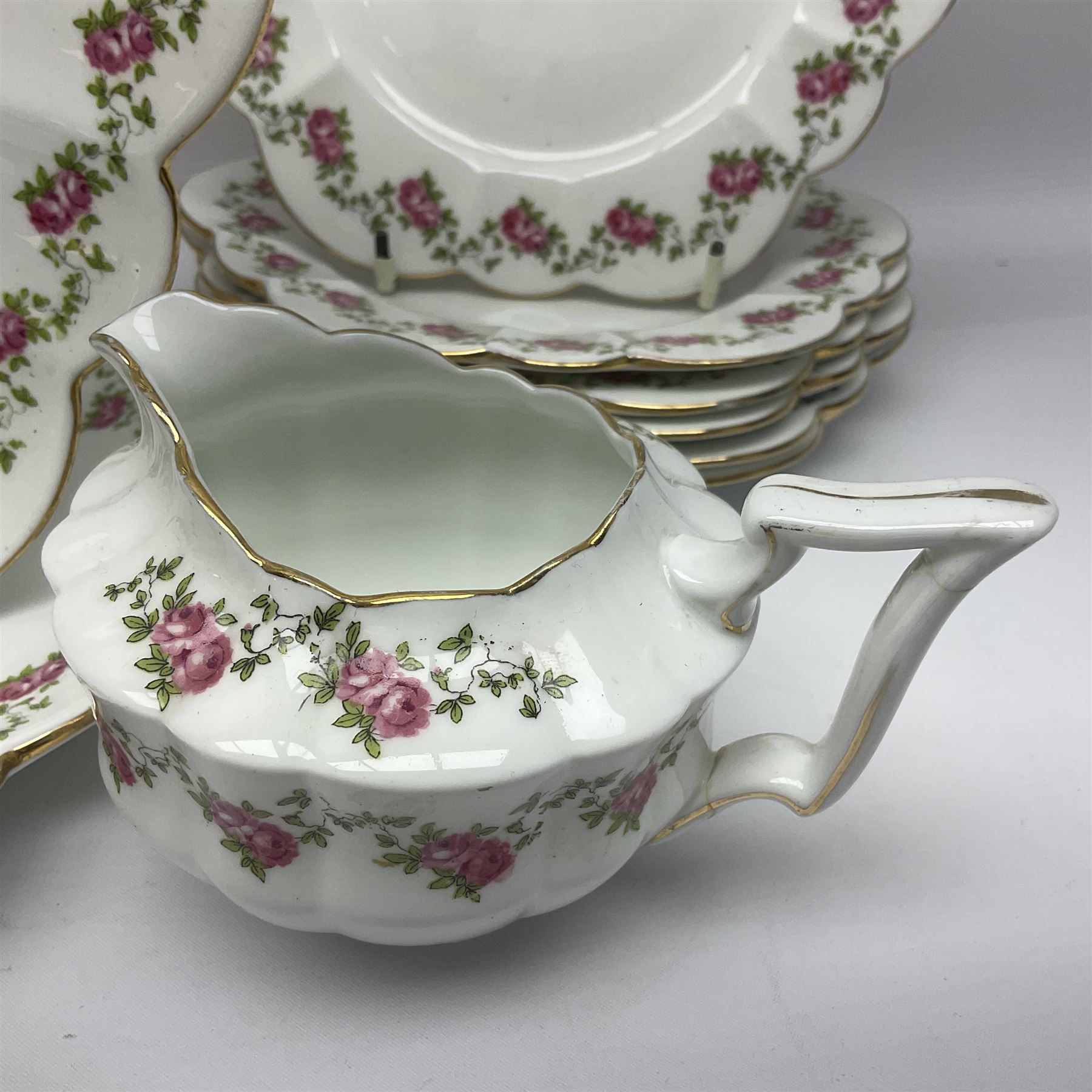 Shelley Late Foley part tea service, pattern number 10137, decorated with roses, comprising eleven teacups and twelve saucers, milk jug, sugar bowl, twelve side plates and two sandwich plates (39)