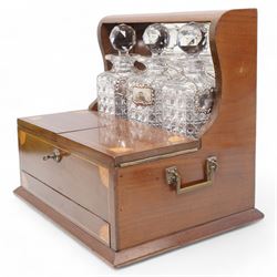 Edwardian walnut and boxwood inlaid tantalus games compendium, having three square section cut glass decanters, with associated silver Brandy, Sherry and Whisky labels, the two hinged doors with Bramah lock, open to reveal a fitted interior with four sherry glasses, over a secret sprung drawer to the base containing a selection of playing cards and cribbage board, L36cm x H32cm 