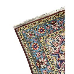 Persian indigo ground rug, overall arabesque design, central multi-point medallion surrounded by scrolling leafy branches and palmettes, the border decorated with repeating stylised plant motifs within guard stripes 