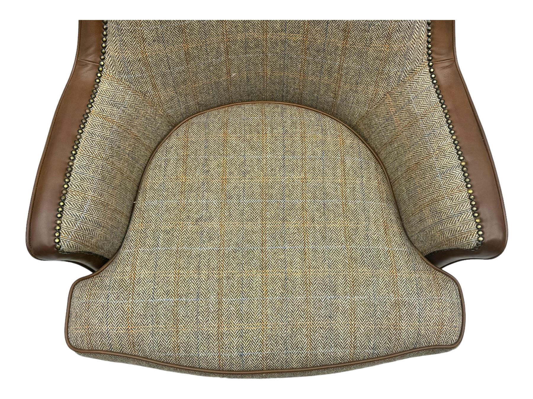 Wood Bros - contemporary wingback armchair, high back with curved wings upholstered in herringbone patterned fabric, accented with leather trim and brass nailhead studs, resting on cabriole front feet 