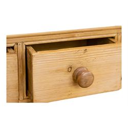 Early to mid-19th century pine cottage dresser, projecting cornice over fretwork frieze, the rack fitted with two shelves over a bank of seven small spice drawers, the base comprising two drawers above an open shelved section