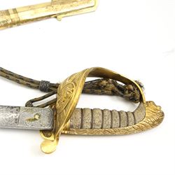 Victorian Naval officers sword by Wilson, King William St., London, the engraved blade with anchor and coat of arms, brass hilt with lion's head pommel and wire wound shagreen grip, blade length 75cm, brass and black leather scabbard