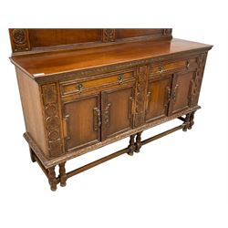 Early 20th century oak sideboard, raised panelled back with foliate carved decoration, rectangular top with gadrooned edge, fitted with two drawers over cupboards with field moulded facias, turned supports joined by stretchers