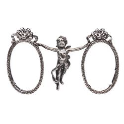 Edwardian silver double photograph frame by Berthold Herrman Muller, the oval frames each with ribbon surmount and supported by a central cherub, H8.5cm