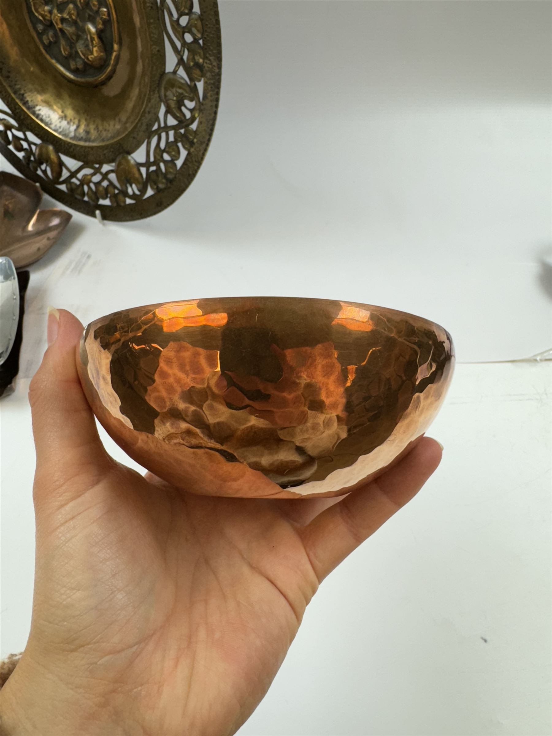 Keswick School of Industrial Arts, flared vase of cylindrical form, together with an Arts and Crafts plated copper, an embossed tray, copper dishes and charger 