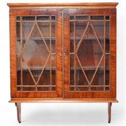 Edwardian inlaid mahogany wall-hanging cabinet, fitted with two astragal glazed doors enclosing two shelves, over shaped brackets