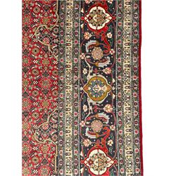 Perisian Bidjar crimson ground rug, within scalloped borders, central pole medallion, the field decorated all over with floral Herati motifs, guarded border decorated with repeating stylised plant motifs and trailing branch 