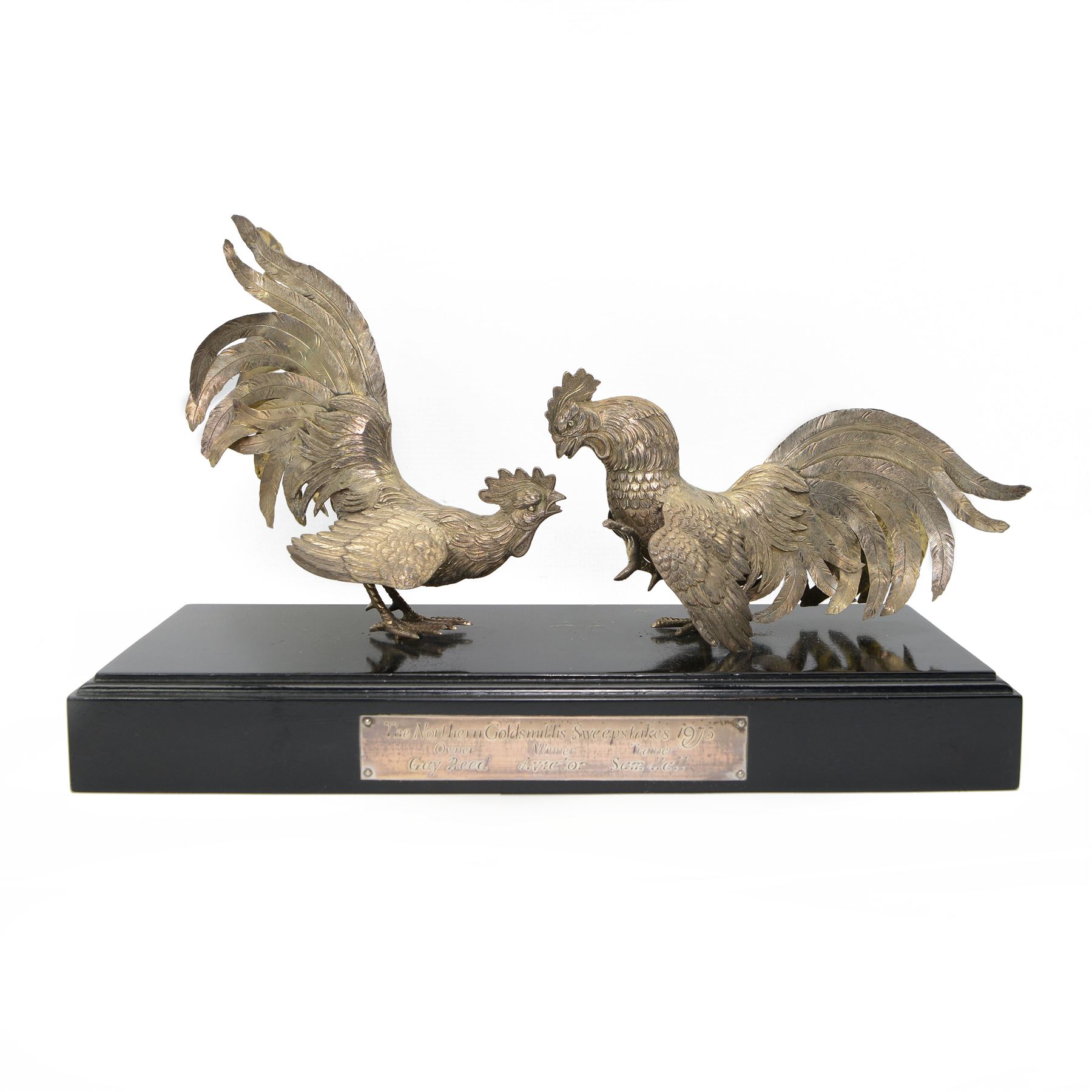 'The Northern Goldsmiths Sweepstakes 1975, Winner Aviator, Owner Guy Reed, Trainer Sam Hall' - A silver trophy modelled as two fighting cockerels on an ebonised plinth with plaque H24cm x W38cm import mark and makers mark for Israel Freeman & Son