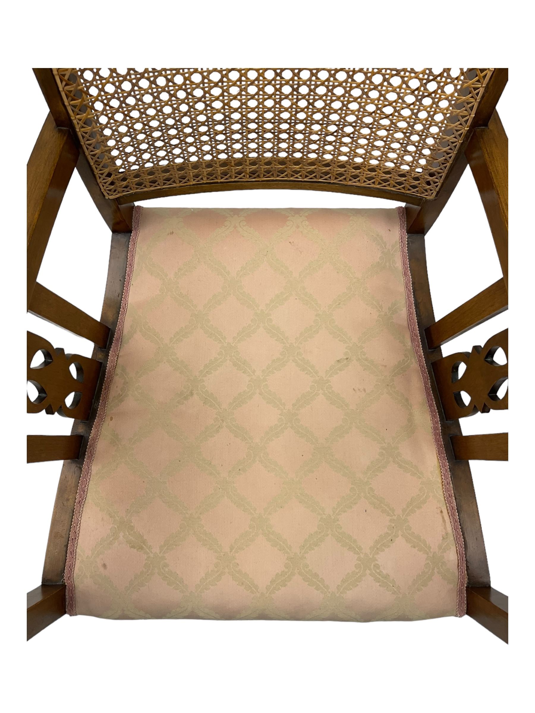 Early 20th century beech framed chair, with scalloped caned backrest, curved arms with pierced splats, upholstered seat in light pink fabric with gold trim, on cabriole supports