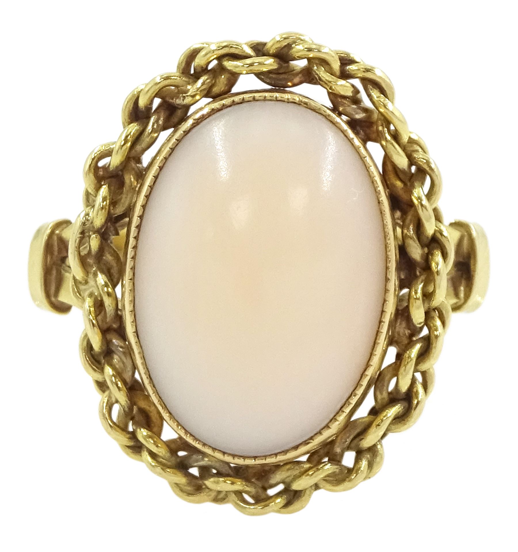 18ct gold single stone coral ring, with chain decoration border, stamped 750