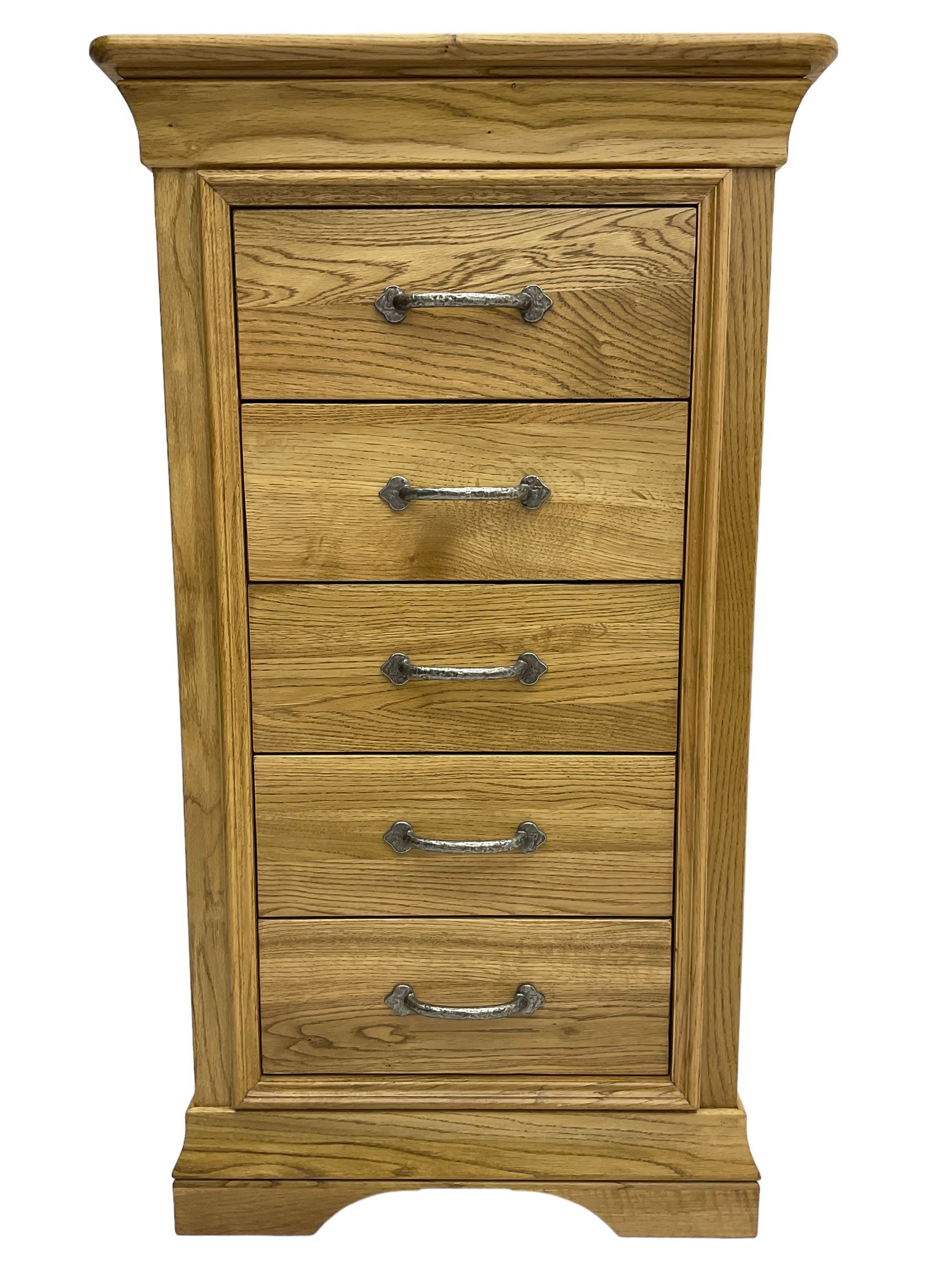 Contemporary light oak pedestal chest, moulded cornice and chamfered rectangular top with rounded fronts, over five drawers with metal handles and cock-beaded surrounds, on bracketed plinth base