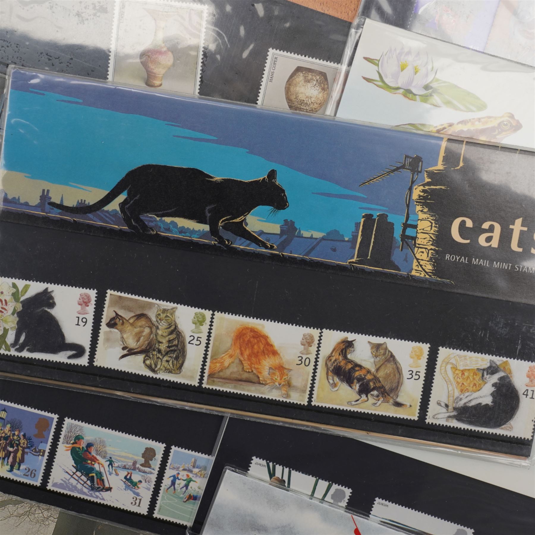 Mostly Queen Elizabeth II mint decimal stamps in presentation packs, including 'Cats', 'Inland Waterways', 'Orchids', 'Wintertime' etc