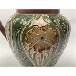 Moorcroft Macintyre Burslem jug, circa 1902, decorated with a motif of stylised flowers amongst scrolling foliage, in shades of brown and green on a peach ground, with printed mark beneath, H16cm