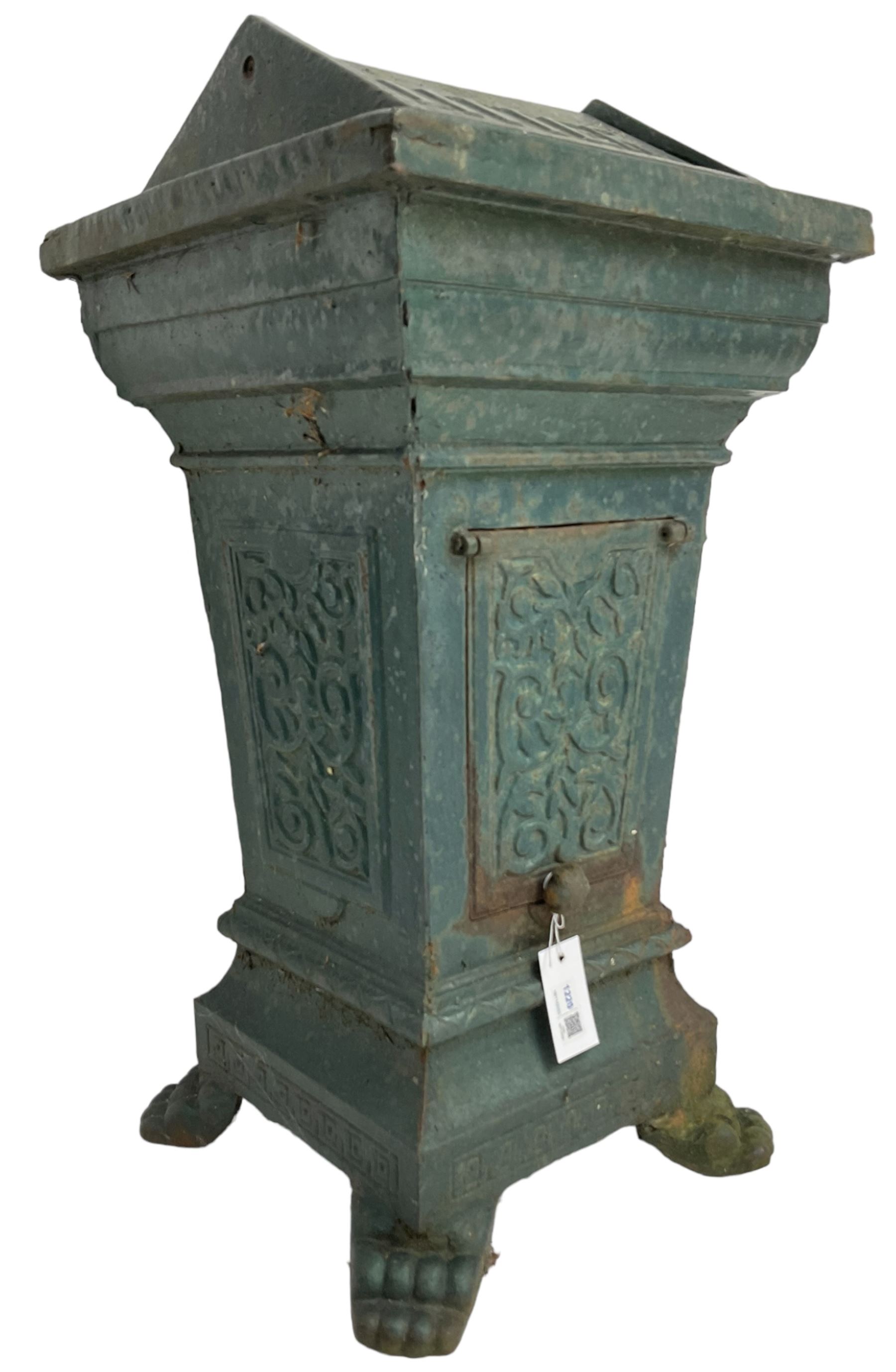 Early 20th century cast iron litter bin, square tapering form with scrolling foliate decoration, on paw feet