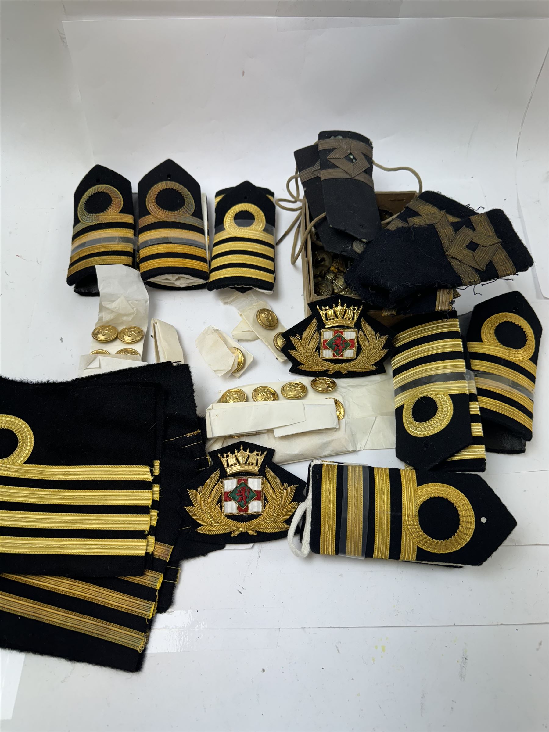 Royal Navy Lieutenant's Frock Coat by Haycock and Jarman, together with other naval accessories, including four pairs of Captain's insignia, six pairs of Captain's shoulder boards, a Merchant Navy cap badge and a collection of other badges, buttons and shoulder boards 