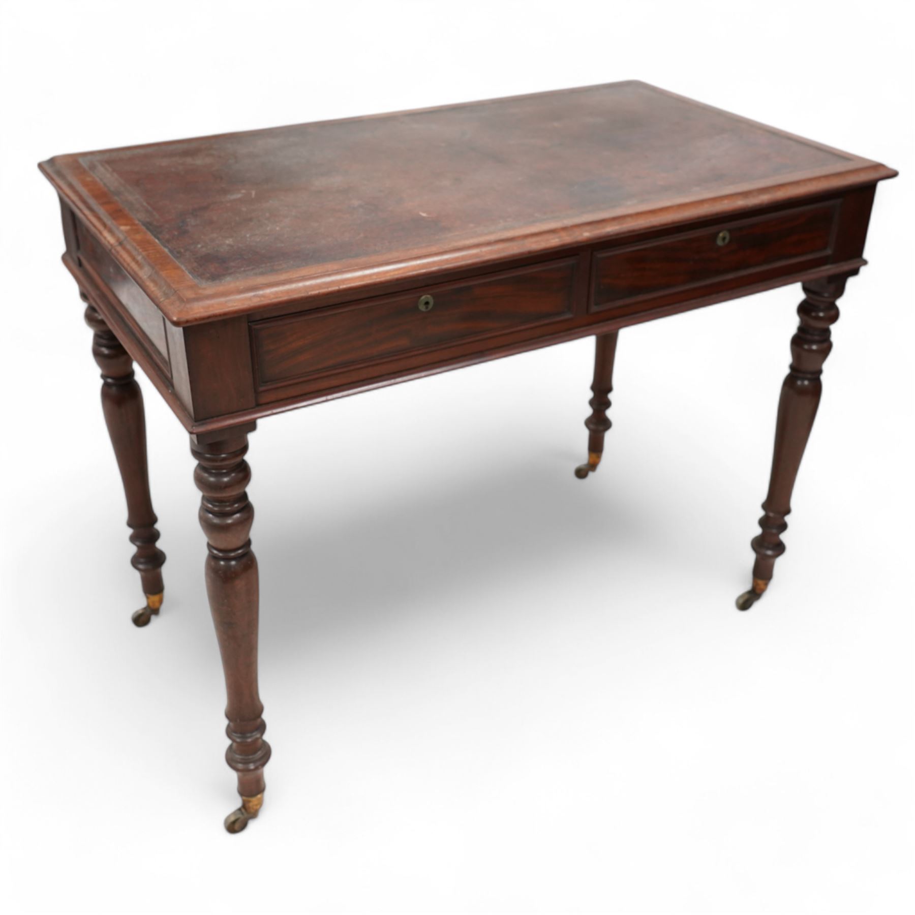 19th century mahogany writing table, rectangular top with moulded edge inset with leather writing surface, fitted with two frieze drawers with moulded facias, raised on turned supports terminating to brass cups and castors