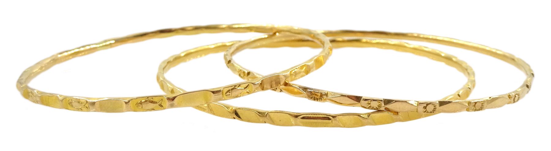 20ct gold Middle Eastern bangle and two similar 19.5ct gold bangles