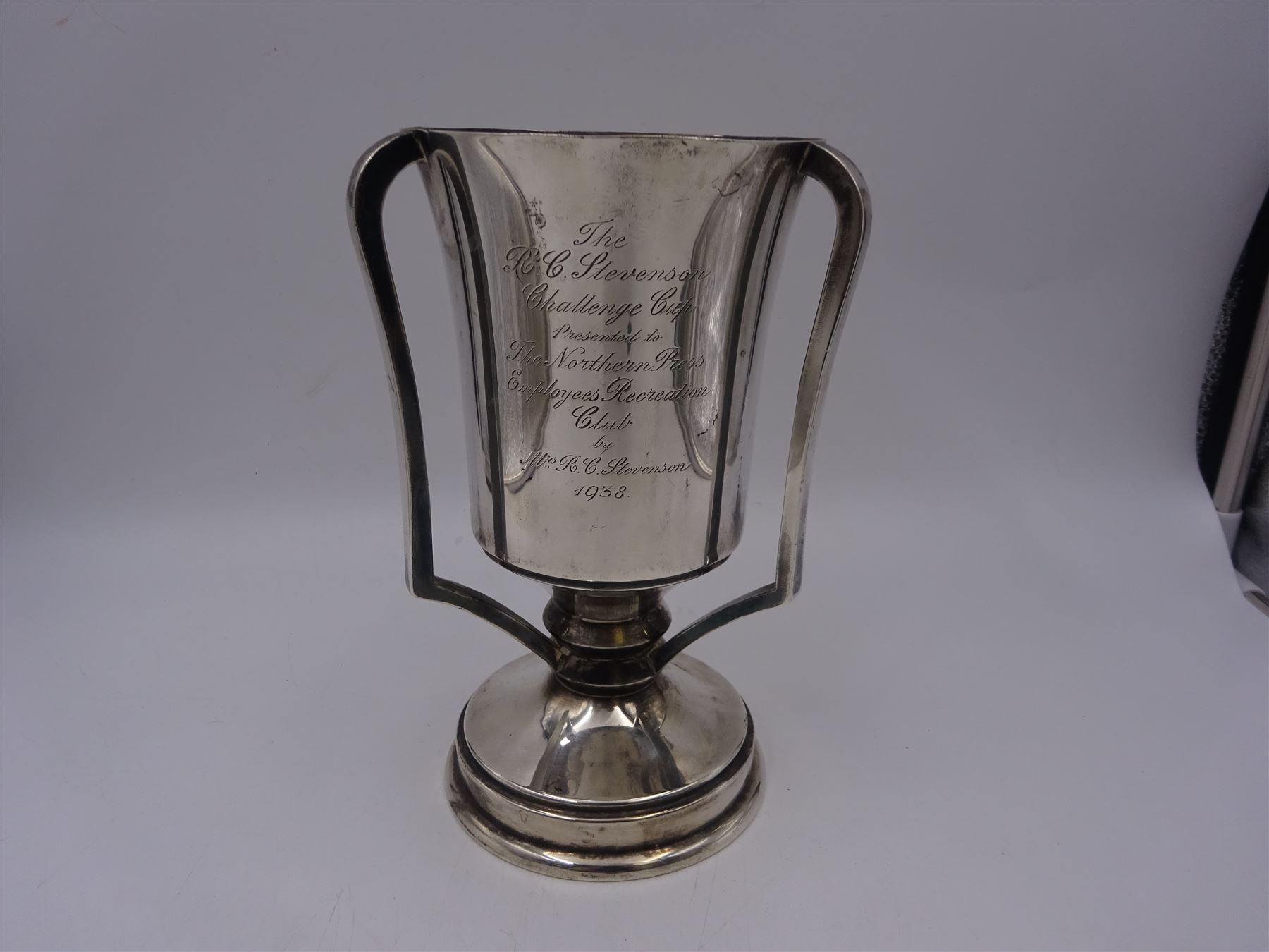 1930s silver three handled trophy, the tapering body inscribed with presentation engraving, upon stepped circular foot, hallmarked Grant & Son, Birmingham 1935, H22cm