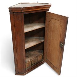 George III oak wall hanging corner cupboard, shaped fielded panelled door enclosing shelves and spice drawers