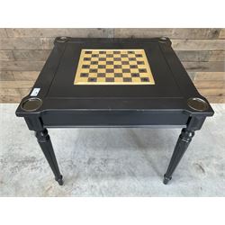 Ebonised square games table, reversible chessboard top revealing games compartment