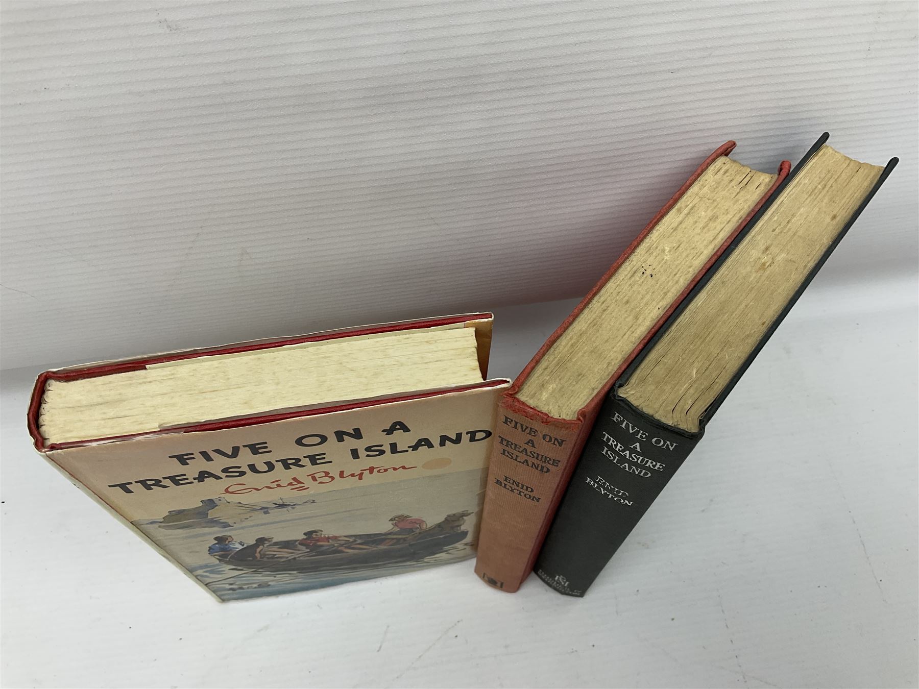 Enid Blyton; three copies of The First Adventure of the Famous Five; Five on Treasure Island, comprising 1963 edition, 1949 edition and 1963 edition  