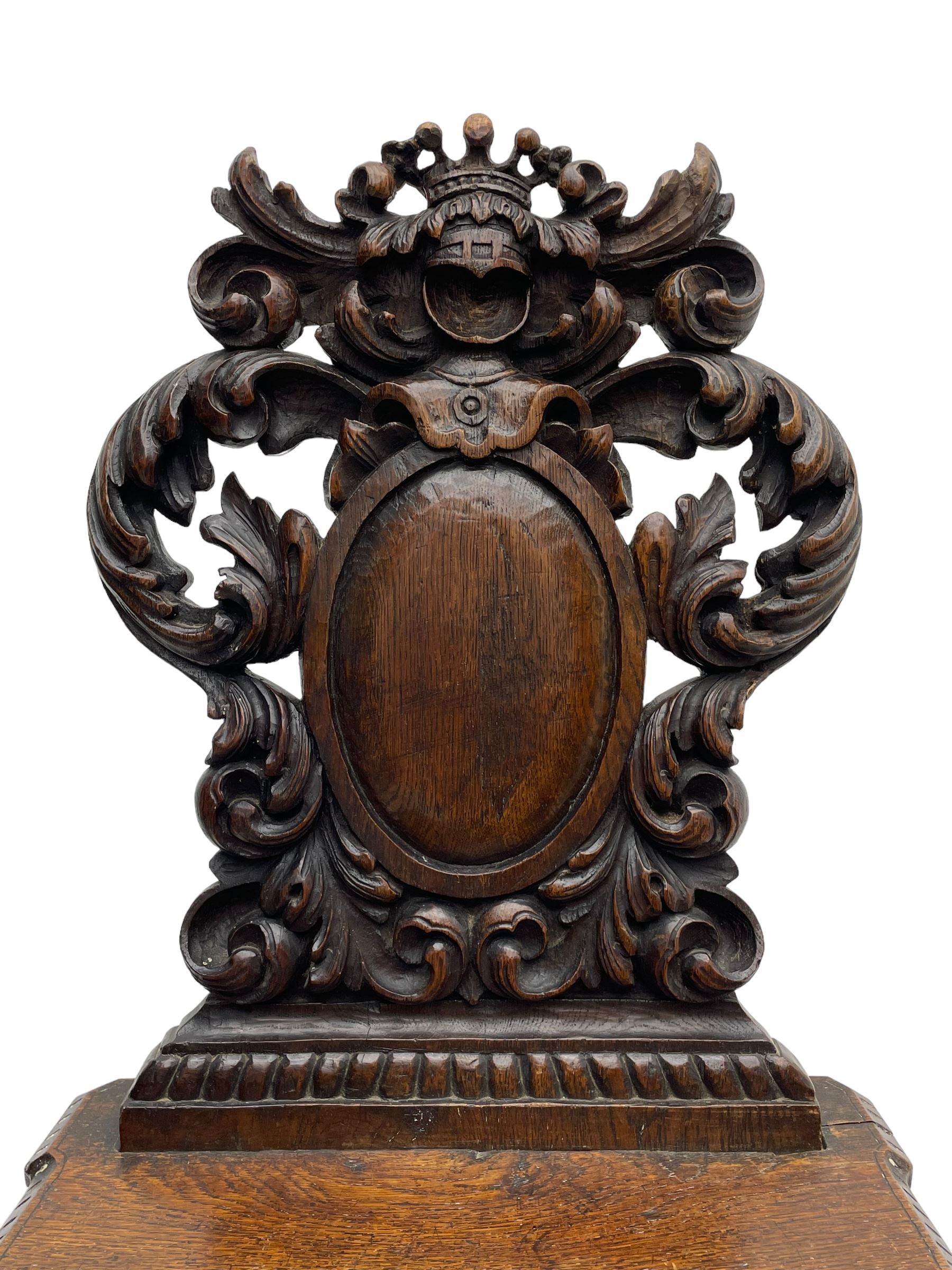 19th century oak hall chair, shaped and pierced back carved with crown cresting over curled and scrolled acanthus leaves, tapered rectangular seat with foliate carved corners and fluted chamfered edge, on turned and lobe carved splayed supports 