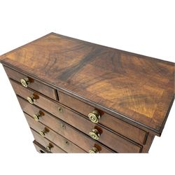 George I walnut chest, moulded rectangular top with book-matched veneers within crossbanding, fitted with two short over four long graduating drawers, moulded drawer fronts with brass handles, on bracket feet, the chest will split into two sections 