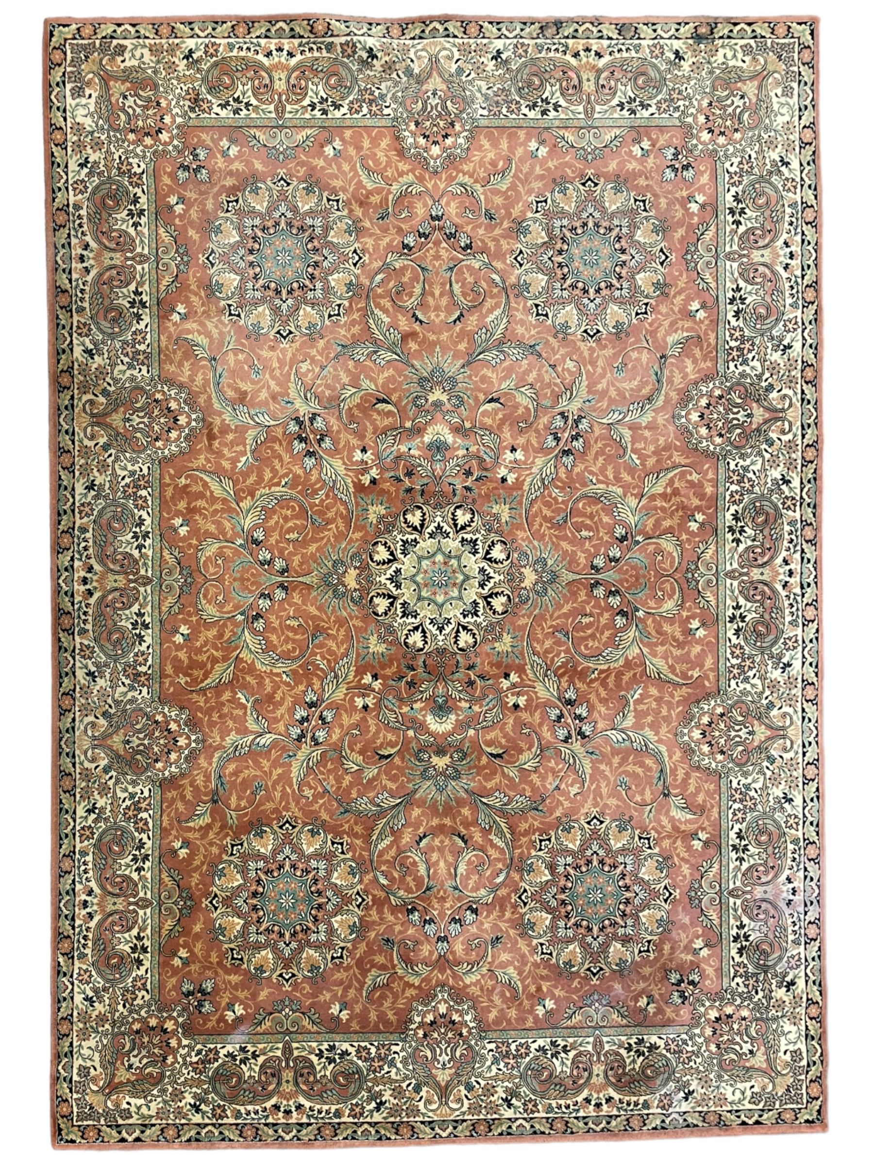 Persian design peach ground carpet, central floral medallion surrounded by scrolling foliage, decorated all over with stylised plant motifs, floral design repeating border