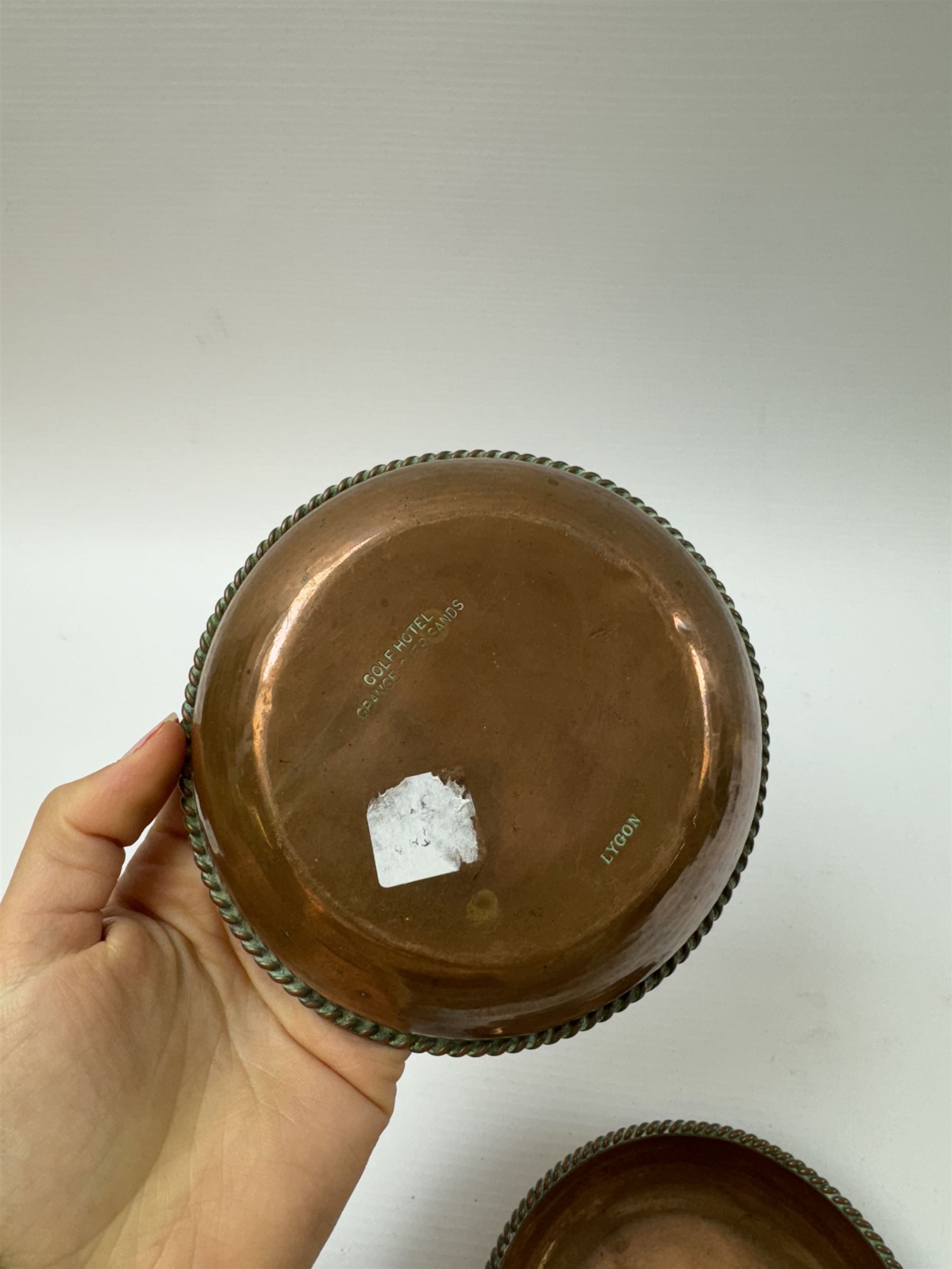 Pair of Arts & Crafts copper dishes by Gordon Russell, with lightly hammered finish and oblique gadrooned rim, impressed beneath 'Golf Hotel Grange Over Sands' and with maker's mark for Lygon