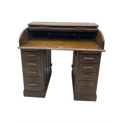 Early 20th century oak twin pedestal roll top desk, tambour roll enclosing fitted interior, each pedestal fitted with four drawers and slide, on plinth base 