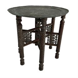 Anglo-Indian Benares table, circular pierced copper top decorated with trailing foliage, on folding hardwood stand carved with scrolls and incised decoration